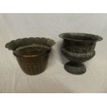A copper circular pedestal planter with incised decoration and one other copper plant holder (2)
