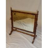 A 19th Century bevelled rectangular wall mirror in mahogany frame with turned supports