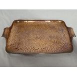 A Newlyn copper rectangular two-handled tea tray with beaten decoration 20" long