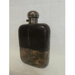 A large silver plated and leather mounted glass hip flask with hinged lid,