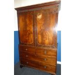 A Victorian figured mahogany linen press with two short and two long drawers below hanging