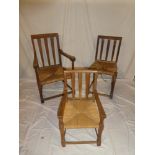 A set of three graduated rustic oak occasional chairs including gentleman's carver chair with