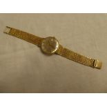 A gentleman's 9ct gold wristwatch by Marvin with silvered circular dial and 9ct gold strap