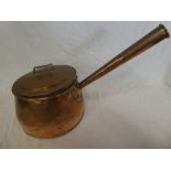 A large 19th Century copper circular saucepan and cover with tapered handle,