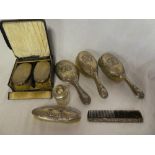 A silver mounted three-piece dressing set comprising a pair of hairbrushes and matching hand mirror