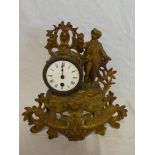 A French gilt Spelter mantel clock with circular enamelled dial in ornate case depicting a young