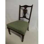 A pair of Victorian carved mahogany nursing style chairs with pierced vase splatbacks and