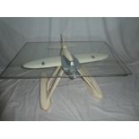 An unusual painted wood glass top coffee table in the form of the Schneider Trophy Seaplane,
