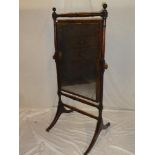 An Edwardian mahogany rectangular cheval mirror on turned supports with splayed feet