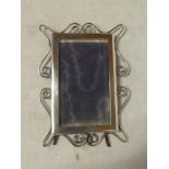 A late Victorian silver rectangular photo frame with ornate scroll mount, Birmingham marks 1898,