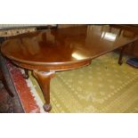 A Victorian mahogany oval extending dining table with two additional centre leaves on cabriole legs