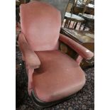 A Victorian mahogany open arm easy chair with burgundy fabric upholstery on turned supports