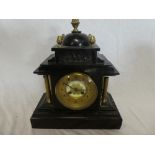 A Victorian mantel clock with gilt circular dial in brass mounted black slate pavilion style case