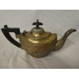 A small Edward VII silver oval tea pot with gadrooned decoration and ebonised handle,