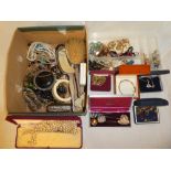 A box containing a large selection of various costume jewellery,