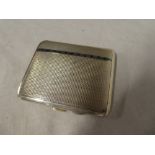 An Art Deco silver and enamelled rectangular cigarette case with engine turned decoration,