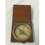 A 19th Century dry card pocket compass with circular dial in brass mounted mahogany square case