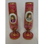 A pair of 19th Century cranberry tinted glass tapered pedestal vases with gilt decoration,