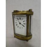 A good quality carriage clock with enamelled rectangular dial in brass oval glazed traditional case