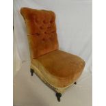 A Victorian nursing style occasional chair upholstered in buttoned fabric on turned tapered legs