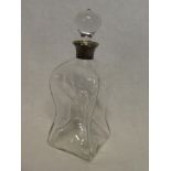 An Edwardian glass square compressed decanter with silver mounted rim,