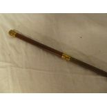 An old leather riding whip with gold plated mounts by Bridges of London
