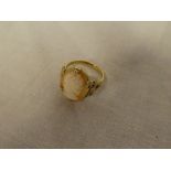 A 9ct gold dress ring with ribbon mount set oval cameo