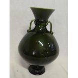An Linthorpe pottery Christopher Dresser design tapered two handled vase with green glazed
