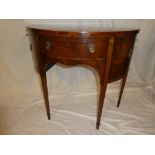 A Victorian inlaid mahogany semi-circular side cabinet with a single drawer in the frieze and