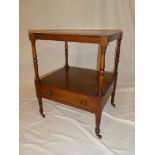 A 19th Century mahogany square two tier night stand with a single drawer in the frieze on turned
