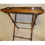 An Edwardian mahogany rectangular butler's tray with matching folding stand on turned supports