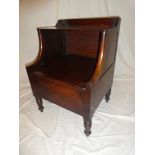 A 19th Century mahogany commode with hinged lid on turned tapered legs