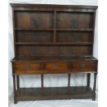 A George III oak dresser with three drawers in the frieze and open pot boards with turned supports,