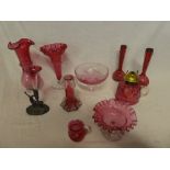 A selection of cranberry tinted glassware including tapered vases,
