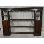 A George III oak and mahogany cross-banded open plate rack with two small drawers below cupboards
