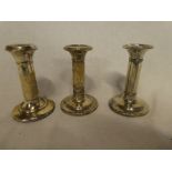 A pair of Edward VII silver candlesticks with plain stems and circular bases, Birmingham marks,