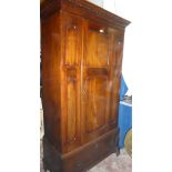 A late Victorian mahogany wardrobe with hanging compartment enclosed by a central panelled door