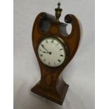 An Edwardian Art Nouveau style mantel clock with enamelled circular dial in inlaid mahogany scroll