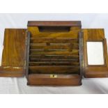 A late Victorian figured walnut stationary box with fitted sloping front enclosed by two doors