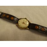 A gentleman's 9ct gold wristwatch by Smiths Deluxe with leather strap and original case