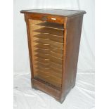 An Edwardian oak stationary cabinet with tambour front by the Stolzenberg File Co, London,