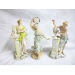 A pair of Continental porcelain male and female classical figures on rocky bases and one other