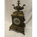 A large 19th Century French brass mantel clock with circular dial and individual porcelain numerals,