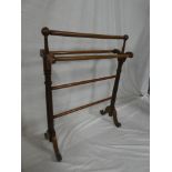 A Victorian walnut towel rail on turned fluted supports