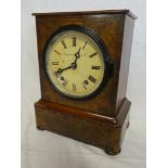An Edwardian mantel clock with painted circular dial by Camerer Cuss & Co in figured walnut