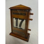 An Edwardian oak perpetual desk calendar in rectangular glazed case,