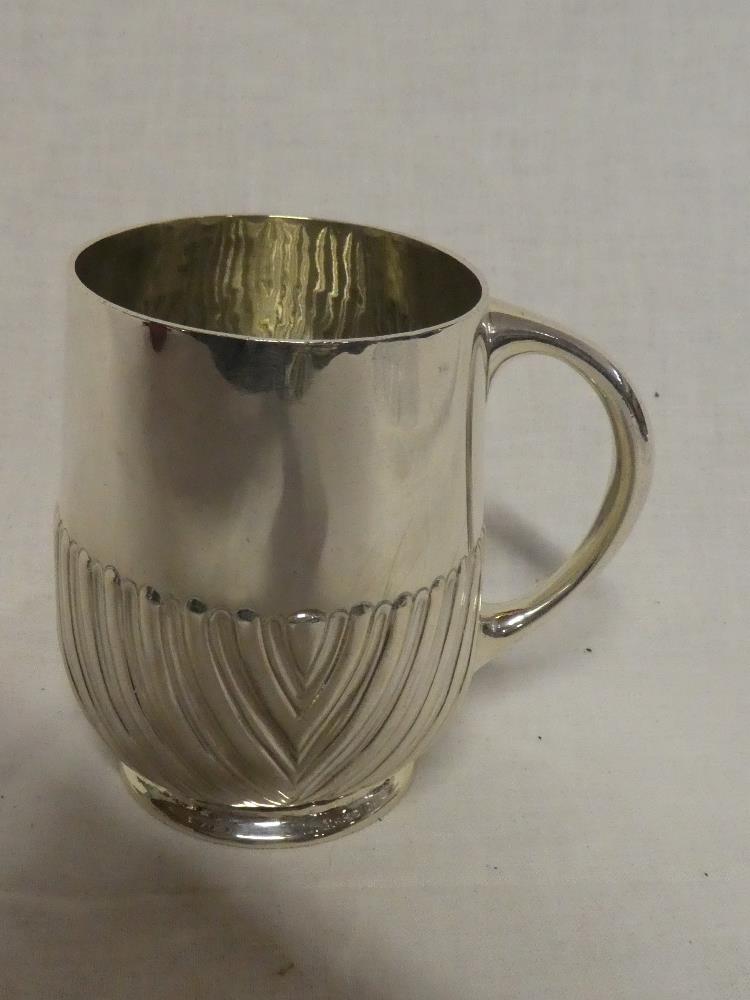 A Victorian silver tankard with gadrooned decoration and loop handle, London marks 1880,