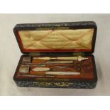 A 19th Century Continental cased sewing set including steel scissors, two thimbles, pencils,