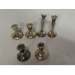 A pair of small silver squat-shaped candlesticks,