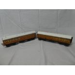 A pair of Leeds Model Company O gauge teak-effect coaches with tin roofs